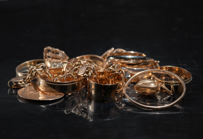 Assorted gold jewelry pieces, including rings and chains, for recycling in Vancouver, BC