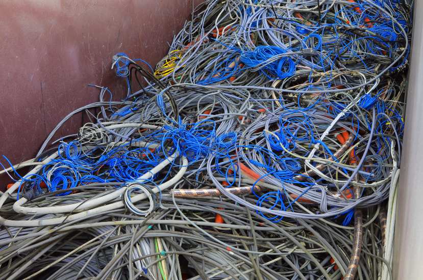 Pile of tangled scrap electrical cables and wires in a recycling container in Vancouver, BC